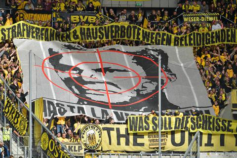 Dortmunder Fans halten in der Rhein-Neckar-Arena ein Transparent mit dem Konterfei von Hoffenheims Mäzen Dietmar Hopp unter einem Fadenkreuz in die Höhe. Foto: dpa