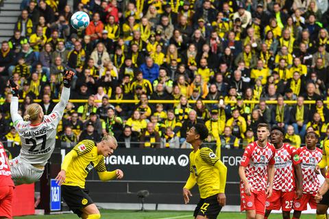 Der Mainzer Keeper Robin Zentner faustet den Ball weg, bevor BVB-Stürmer Erling Haaland einköpfen kann. Foto: dpa
